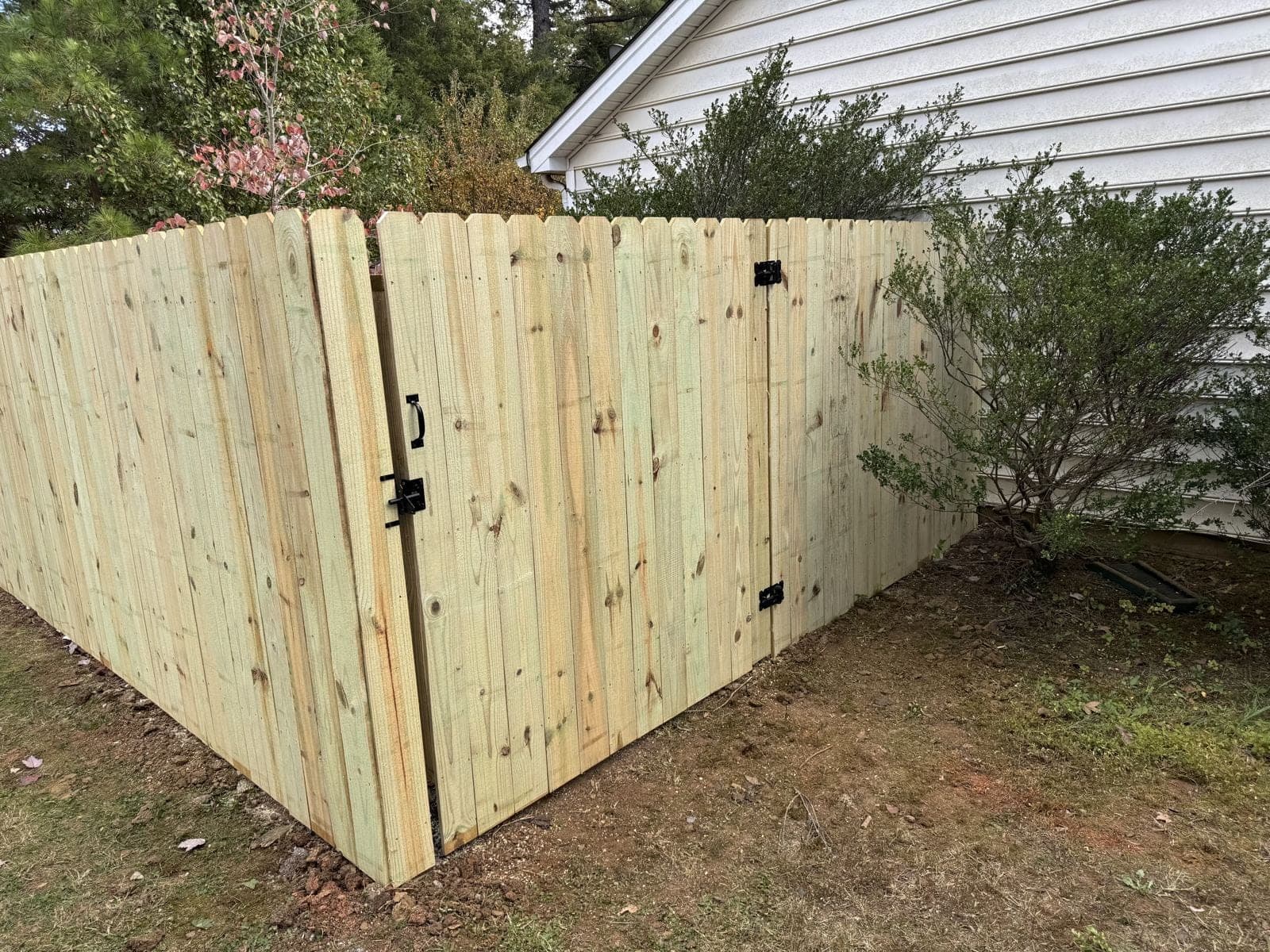 A beautiful wooden fence stained and sealed in a Carolina backyard.