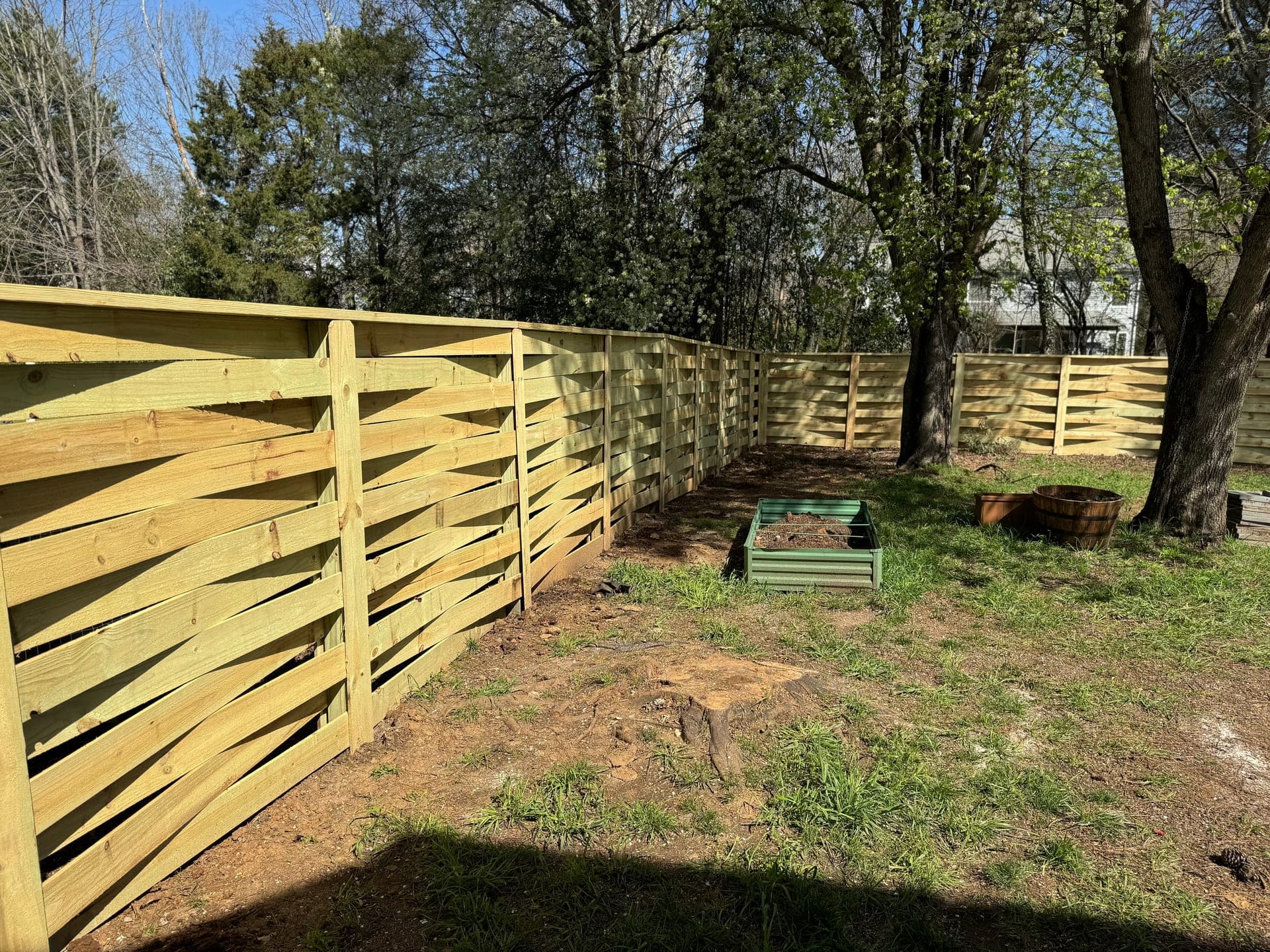Modern horizontal fence design in a residential backyard setting