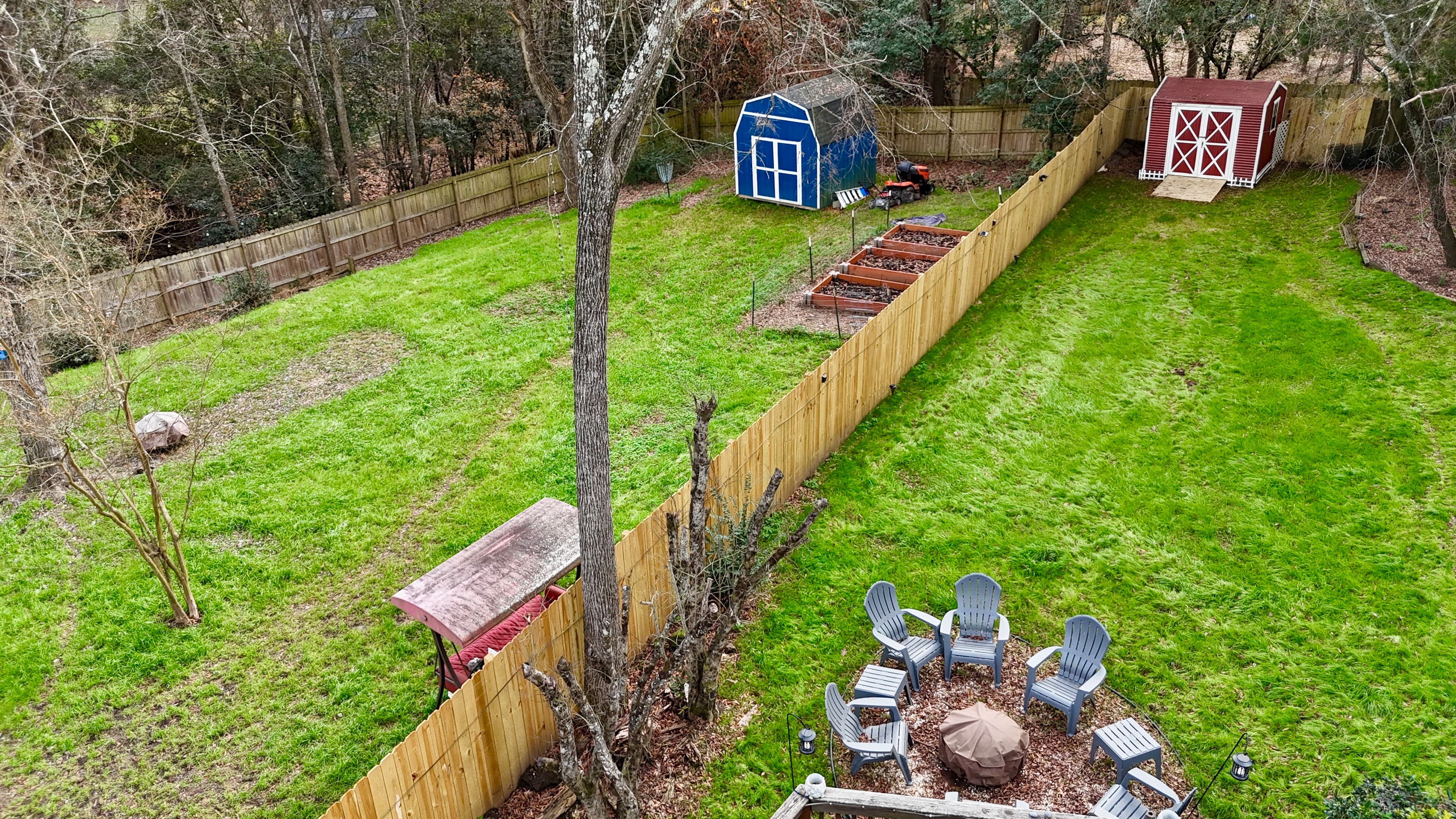 A 6-foot wooden privacy fence in a suburban Charlotte neighborhood surrounded by greenery.